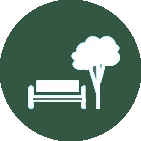 A white icon of a bench and a tree in a green circle.