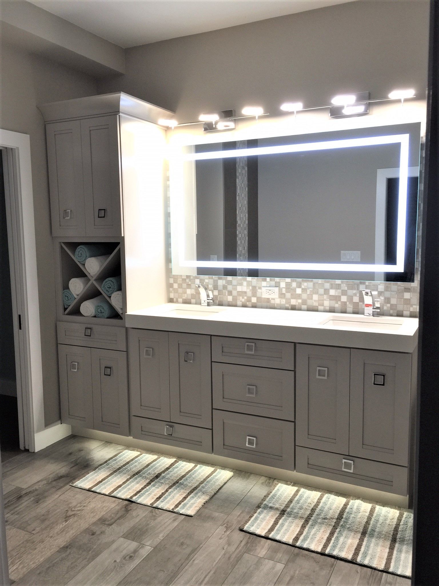 A bathroom with two sinks and a large mirror.