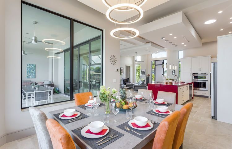 A dining room table with plates and bowls on it in a house.