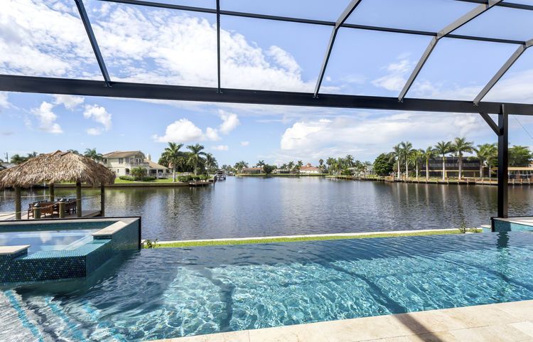 A large swimming pool with a view of a lake.
