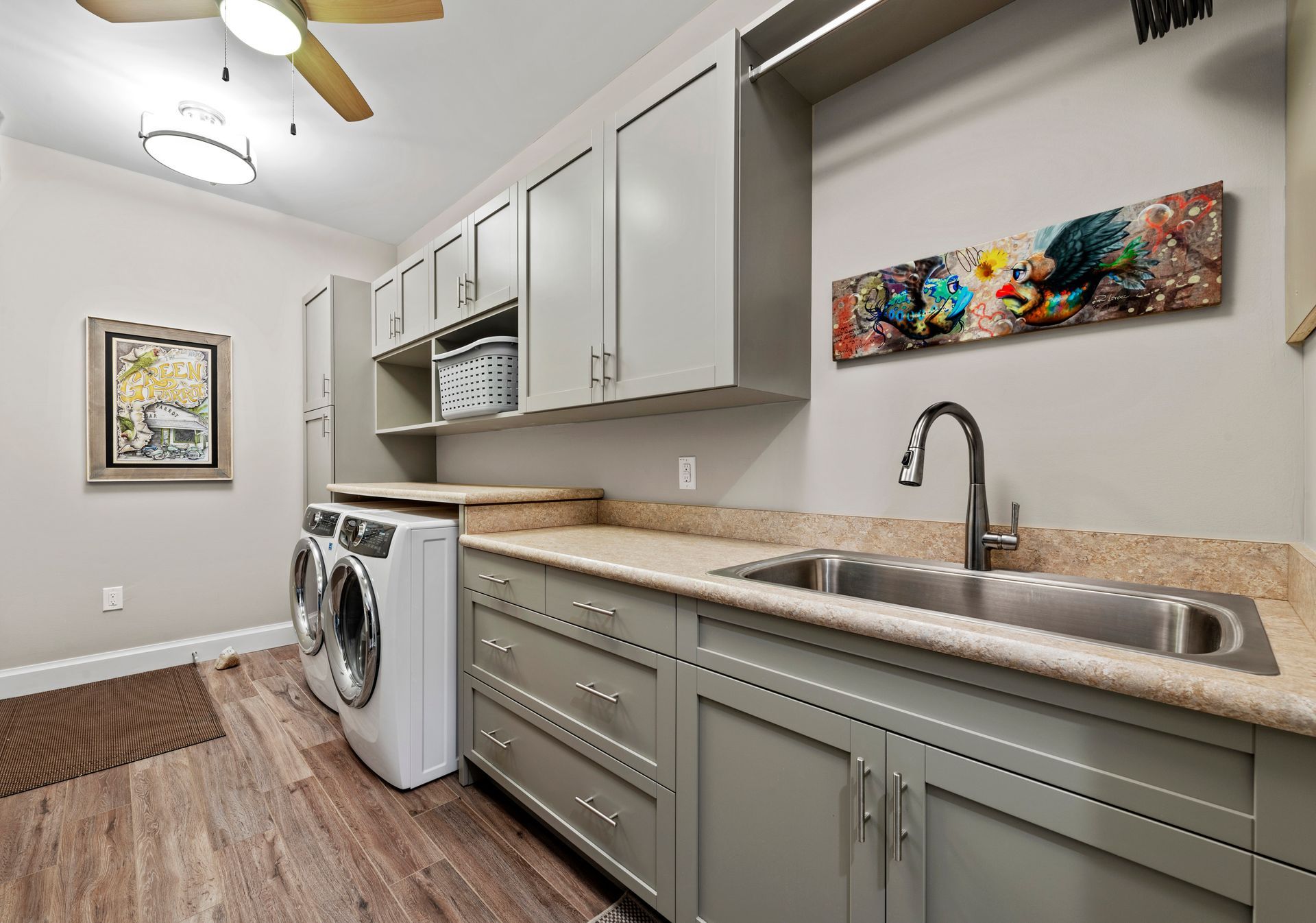 A laundry room with a washer and dryer and a sink.