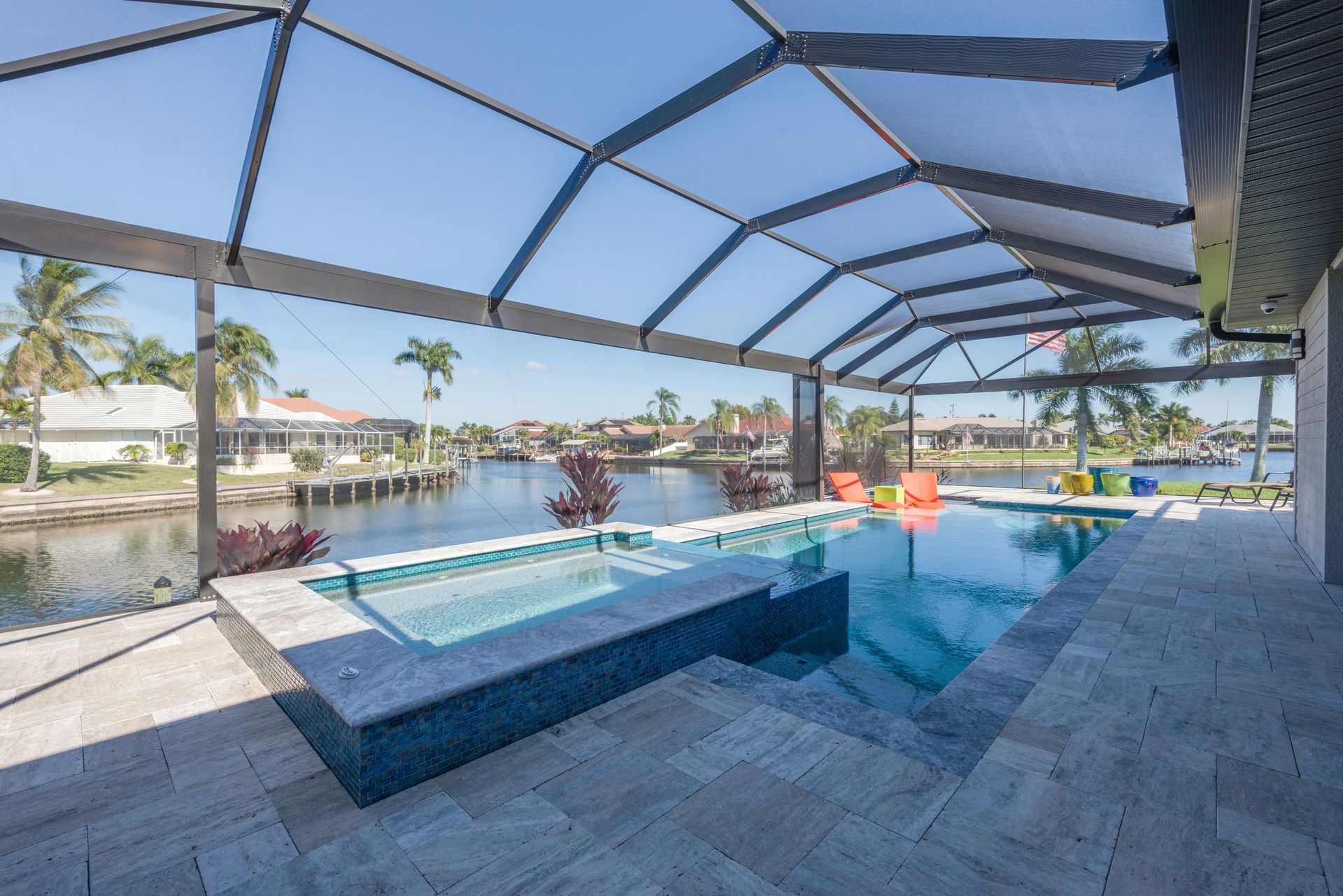 A large swimming pool with a gazebo overlooking a body of water.
