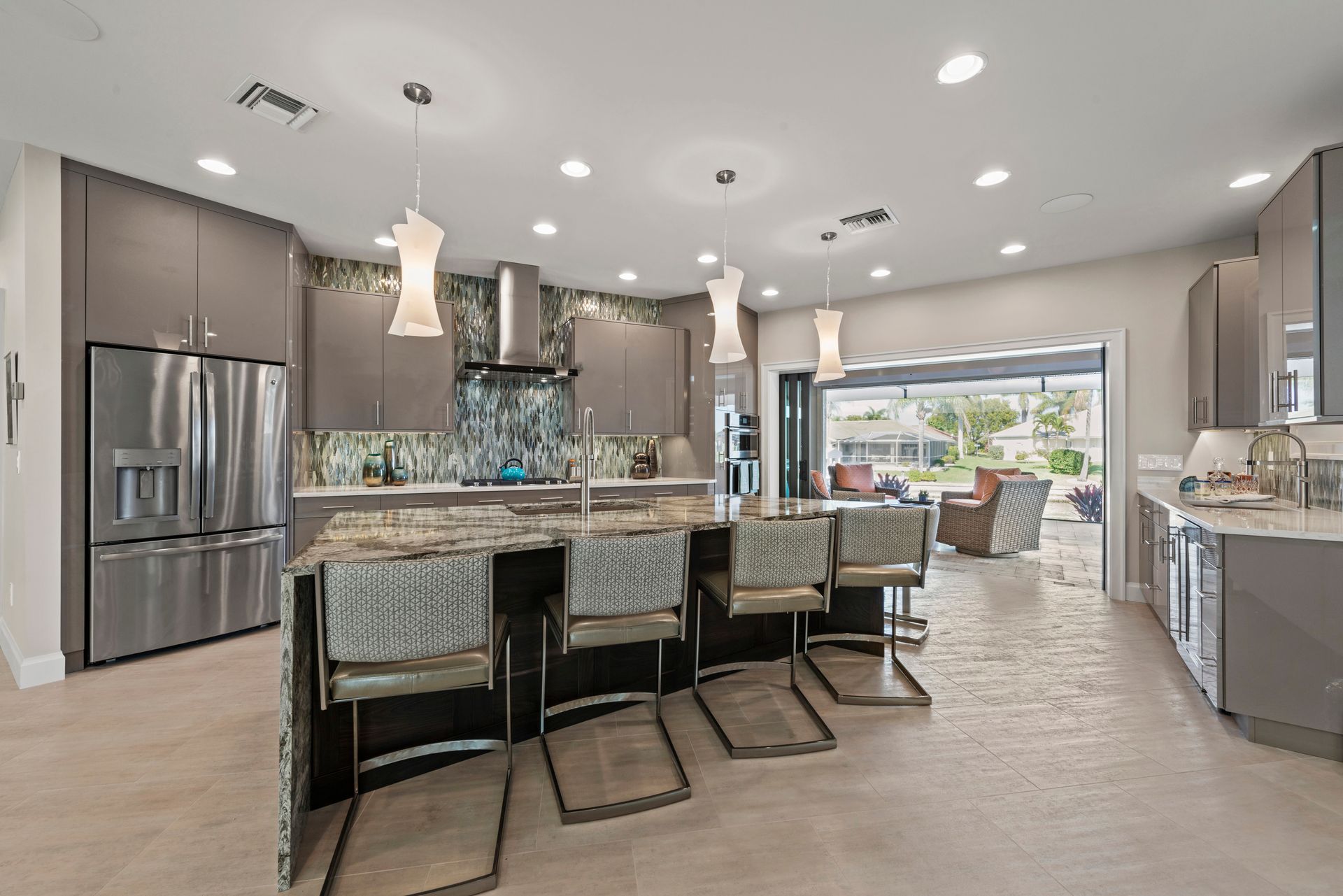 A kitchen with stainless steel appliances , granite counter tops , and a large island.