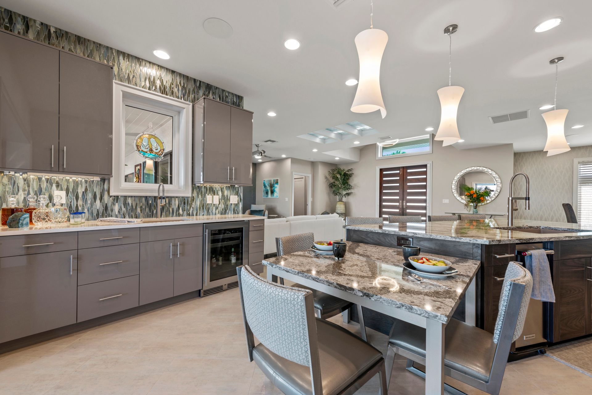 A kitchen with a dining table and chairs in it.