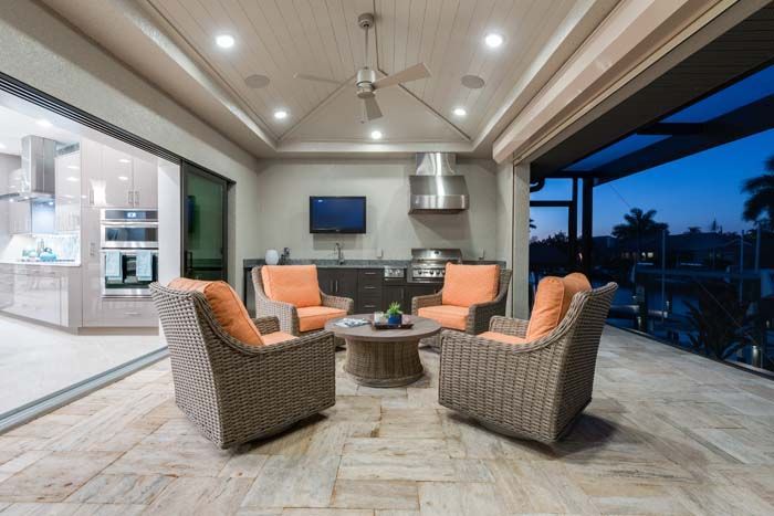 A patio with chairs , a table and a television.