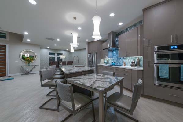 A kitchen with a table and chairs in it