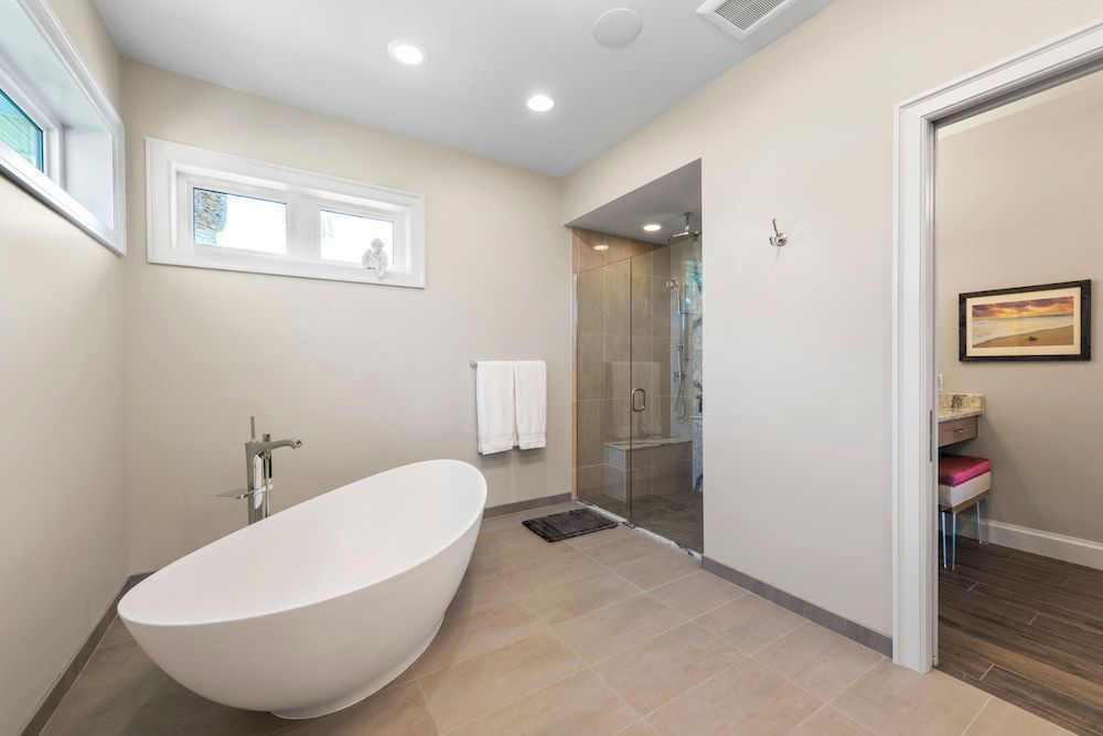 A bathroom with a bathtub and a walk in shower.