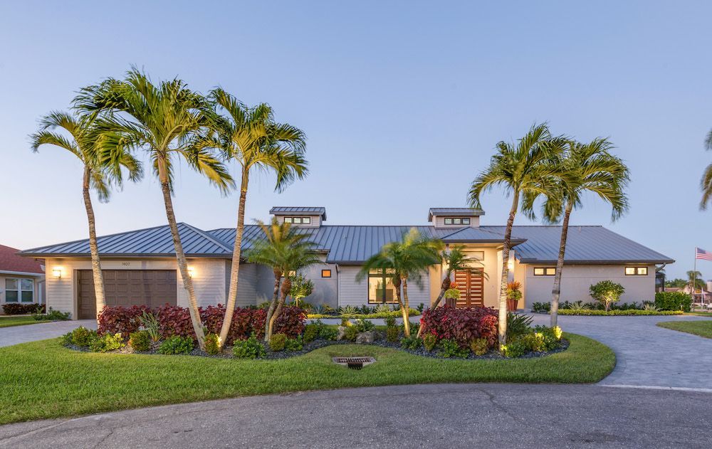 A large house with palm trees in front of it
