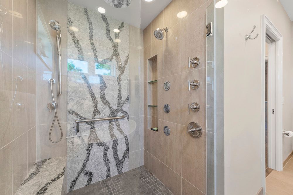 A bathroom with a walk in shower and a toilet.