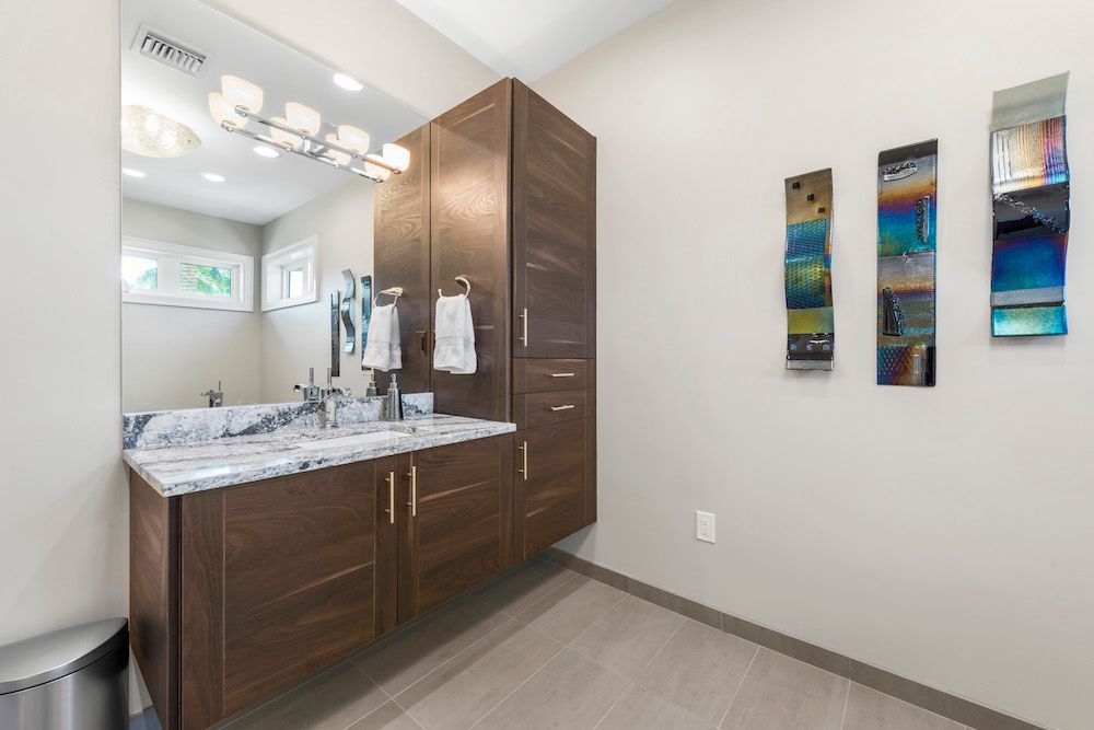 A bathroom with two sinks and a large mirror.