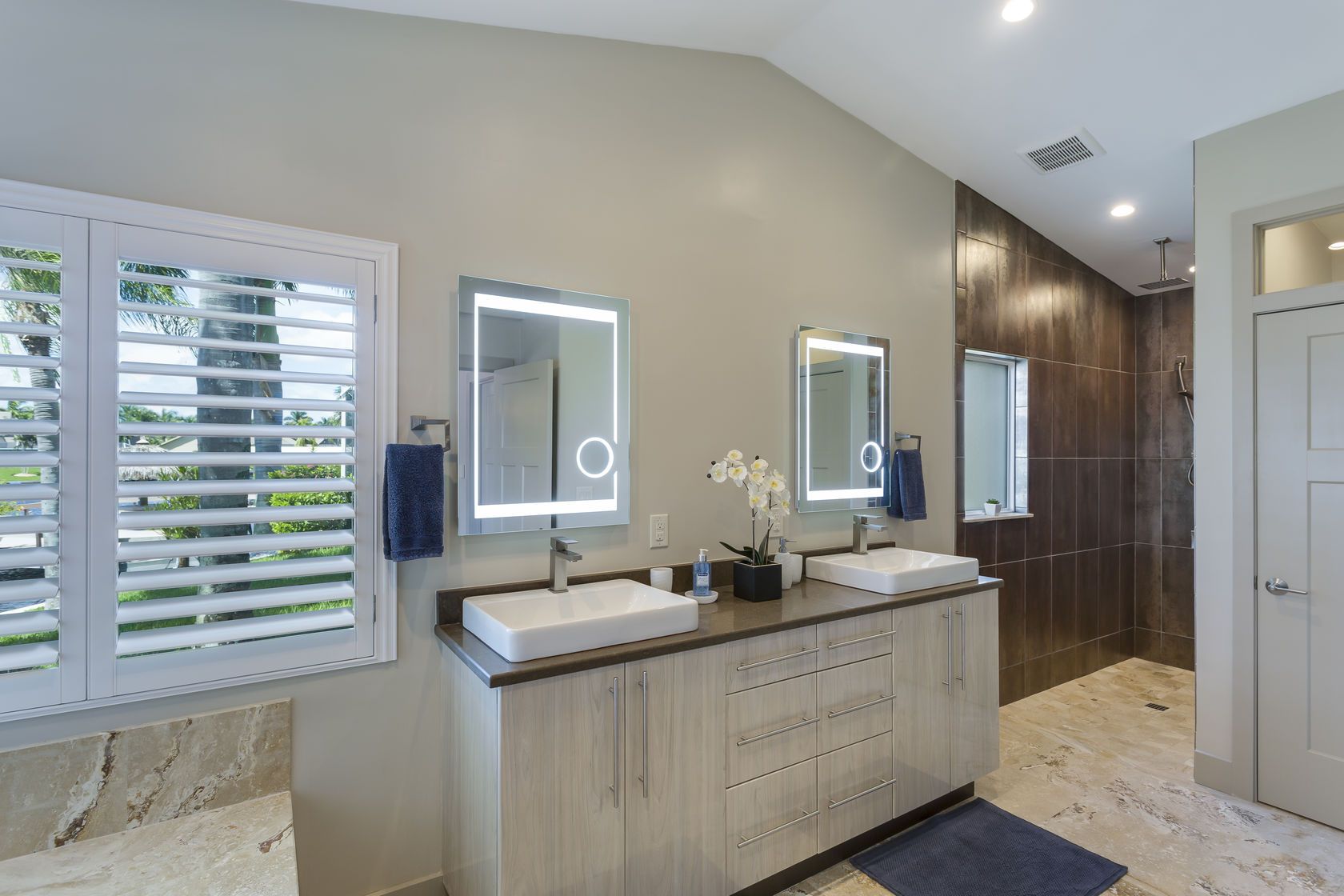 A bathroom with two sinks and two mirrors.