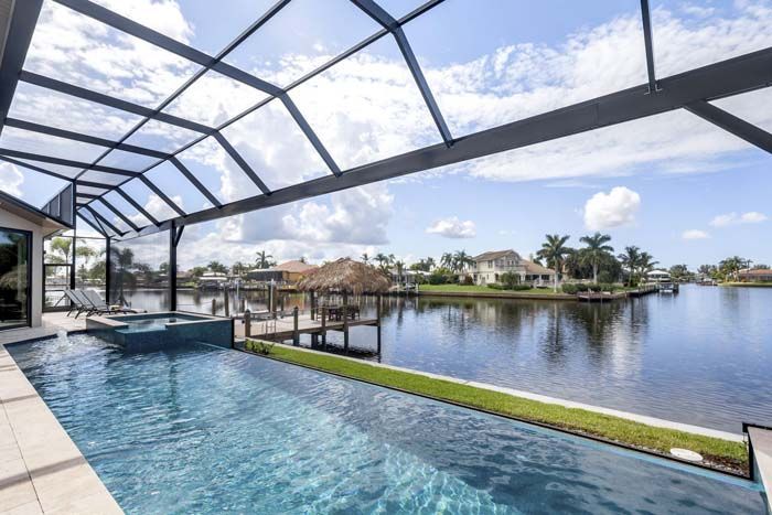 A large swimming pool with a view of a lake.
