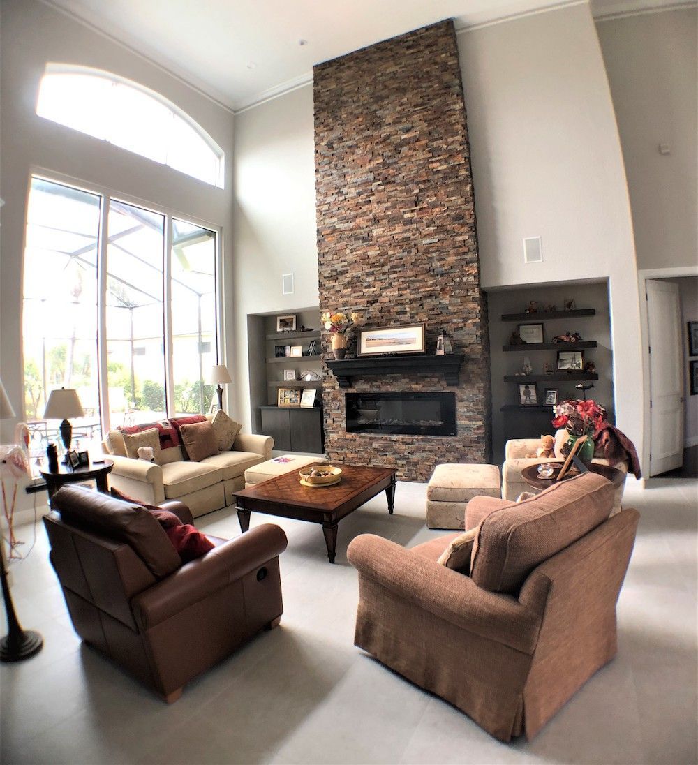 A living room filled with furniture and a stone fireplace