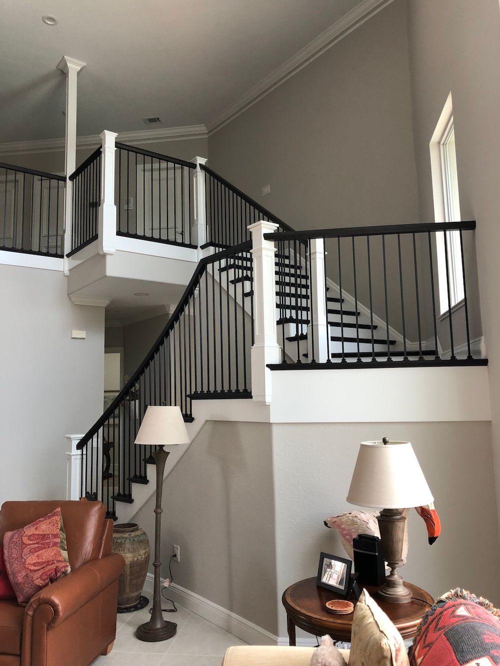 A living room with stairs leading up to the second floor