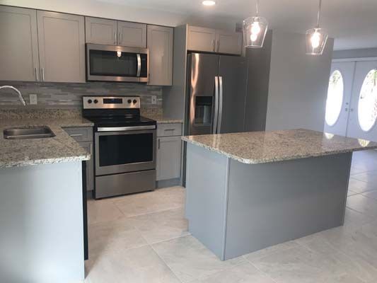 A kitchen with stainless steel appliances and granite counter tops