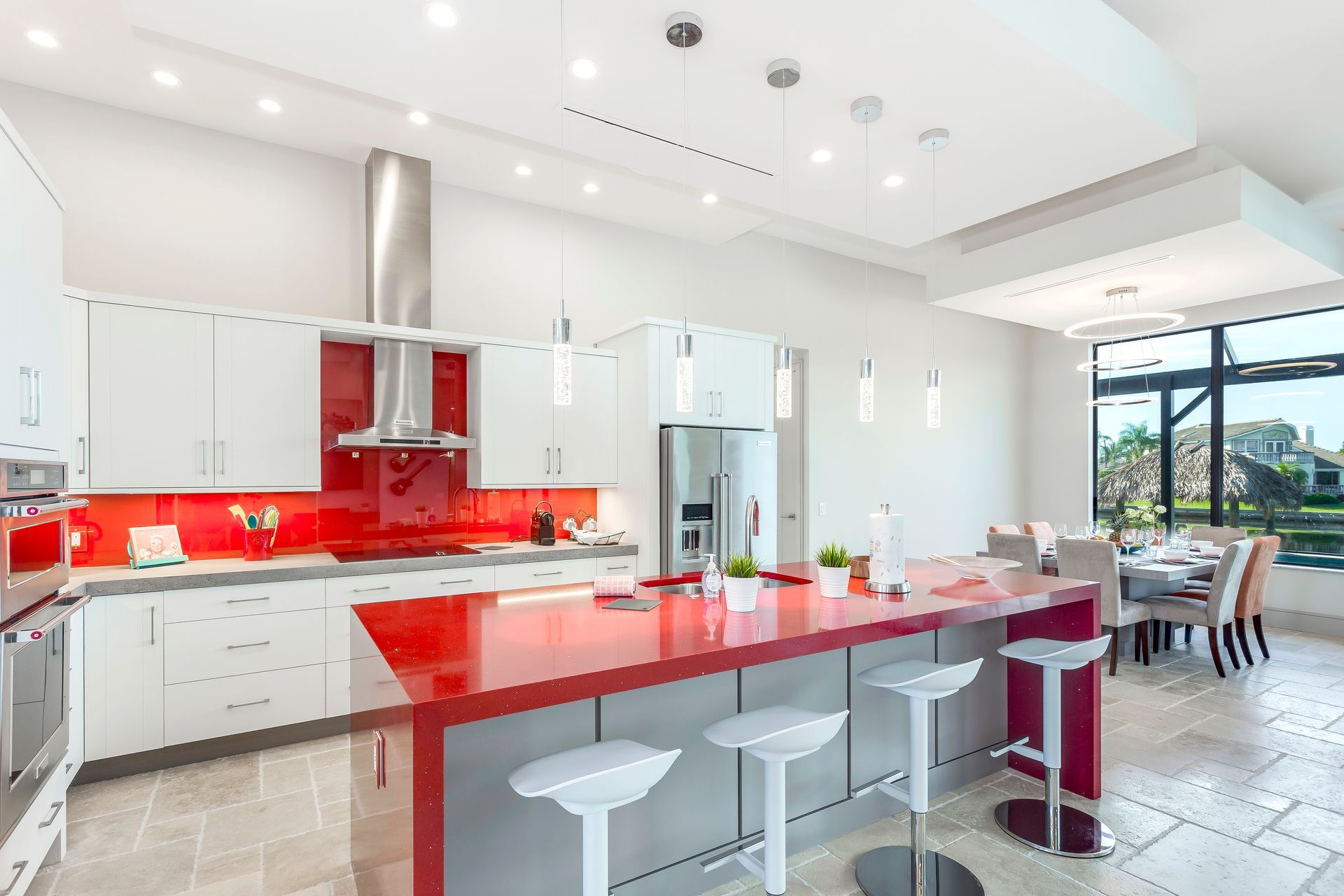 A kitchen with red counter tops and white cabinets
