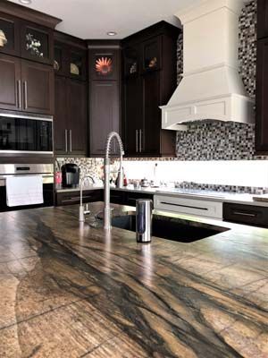 A kitchen with a sink , stove , and microwave.