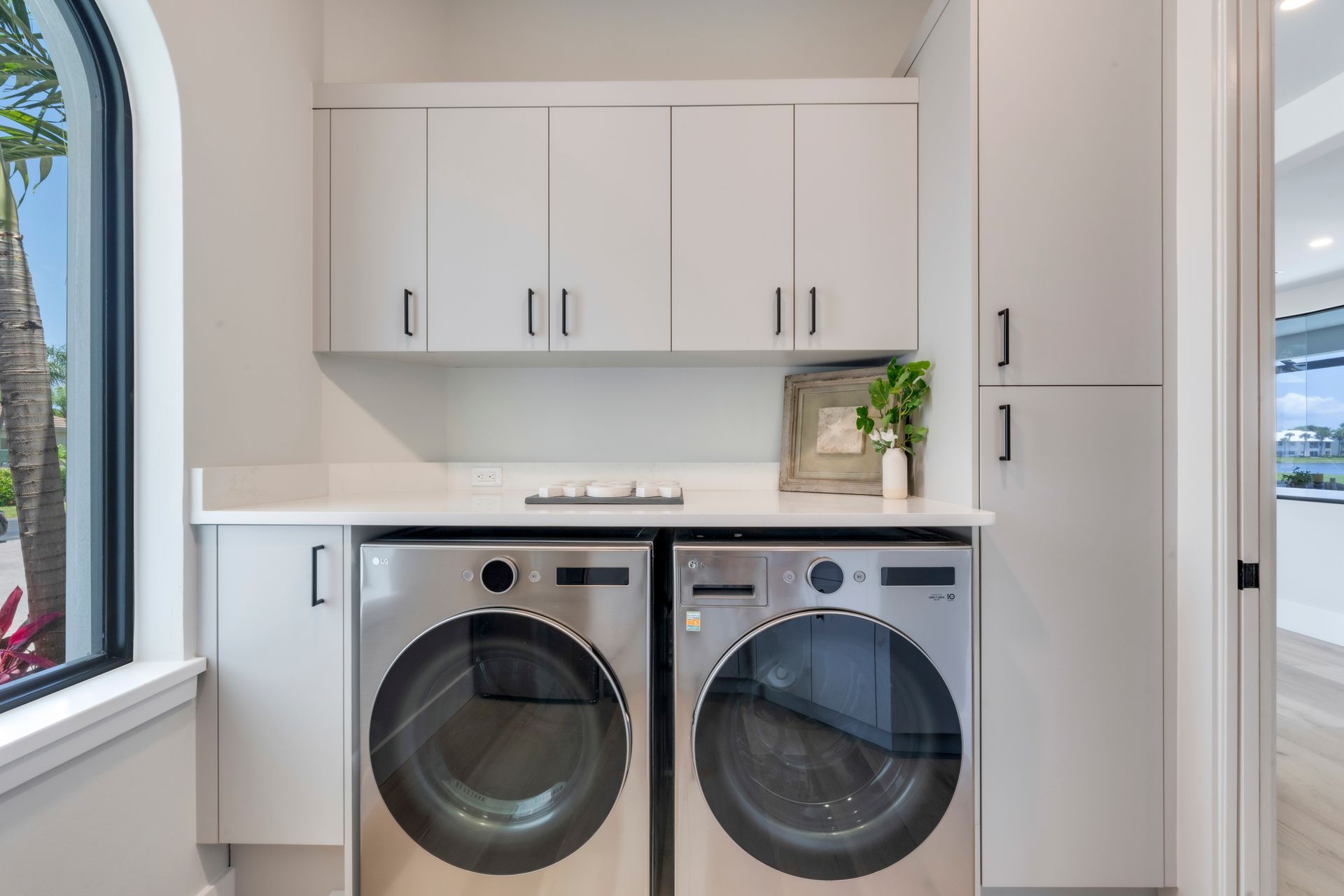 A laundry room with a washer and dryer and a window.