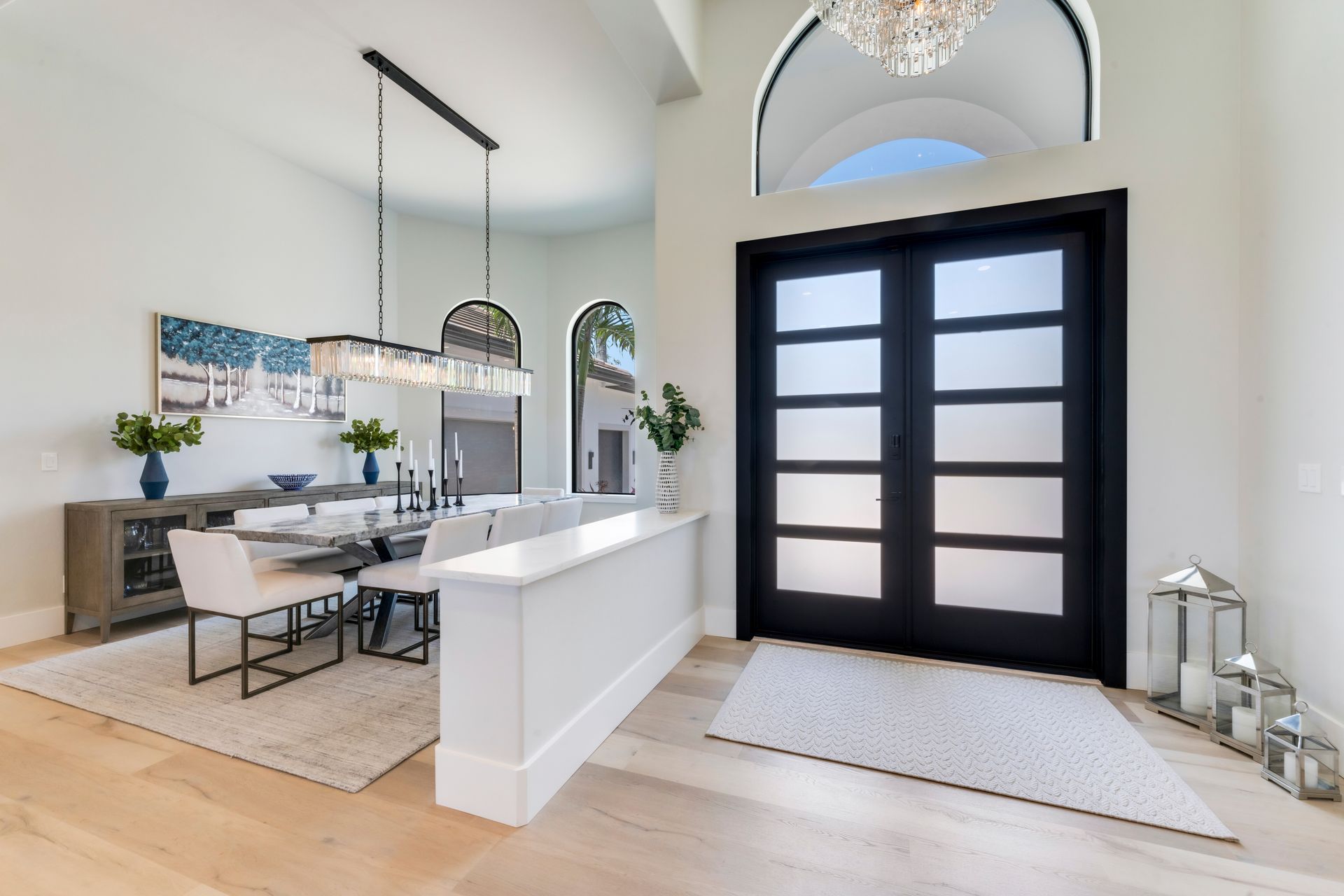 A kitchen with blue cabinets and white counter tops.
