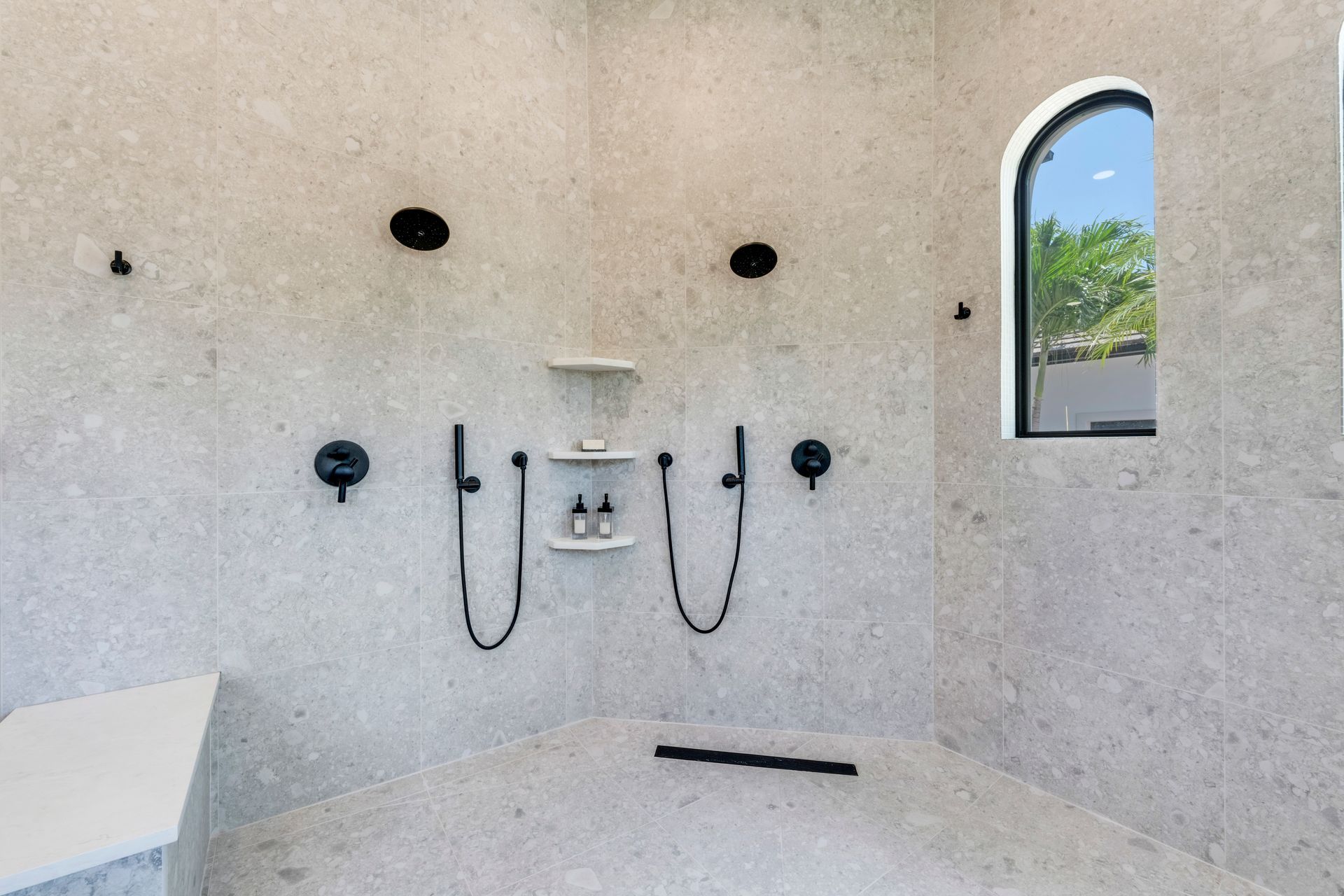 A bathroom with a large shower and a window