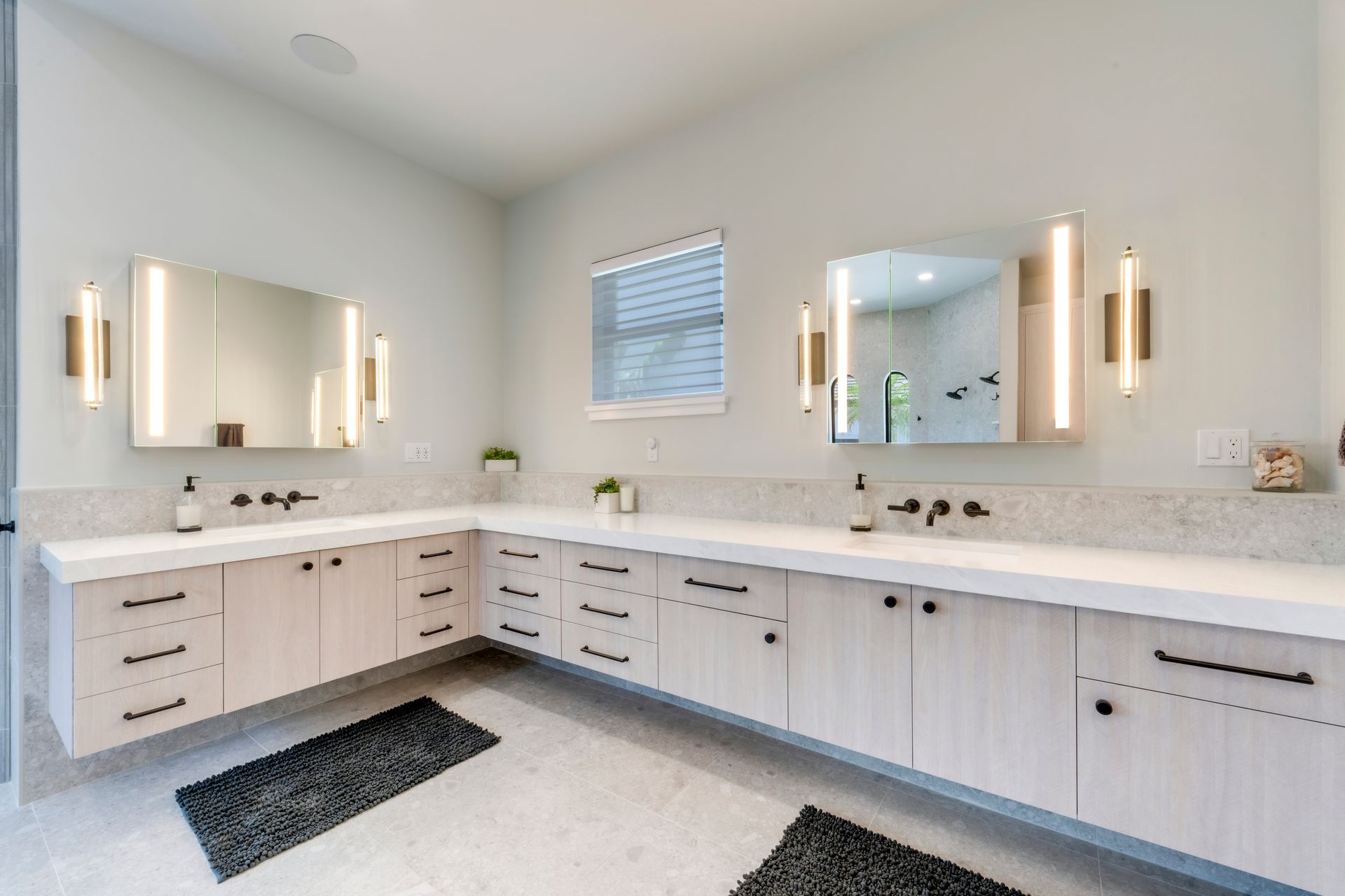 A bathroom with two sinks and two mirrors.