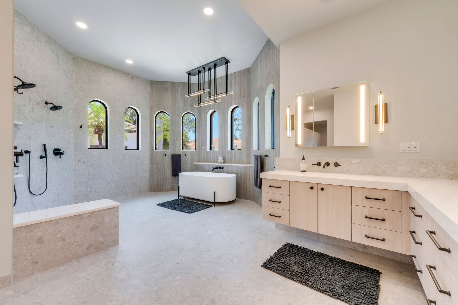 A bathroom with a bathtub , sinks , and mirrors