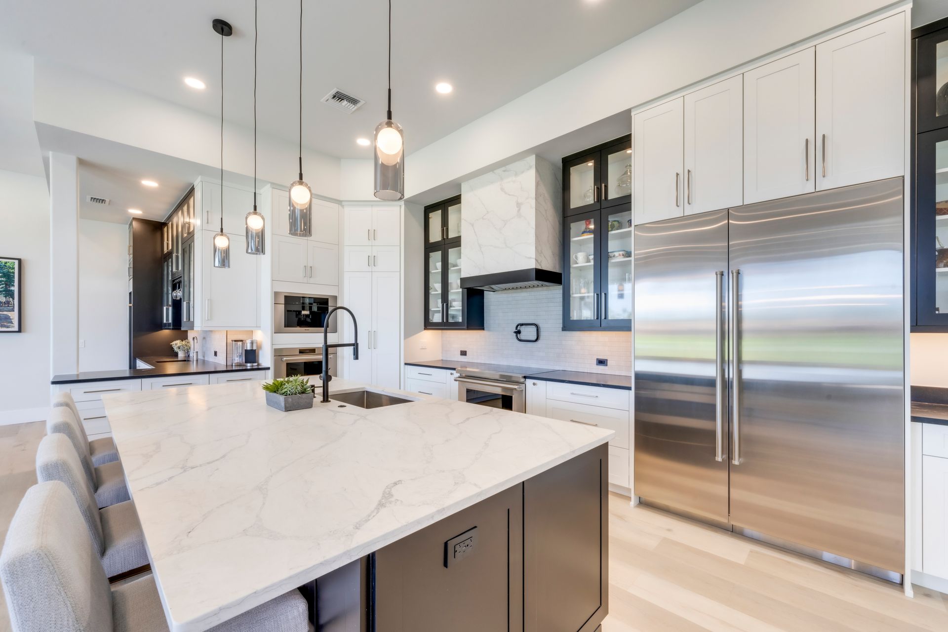 A kitchen with stainless steel appliances and a large island.