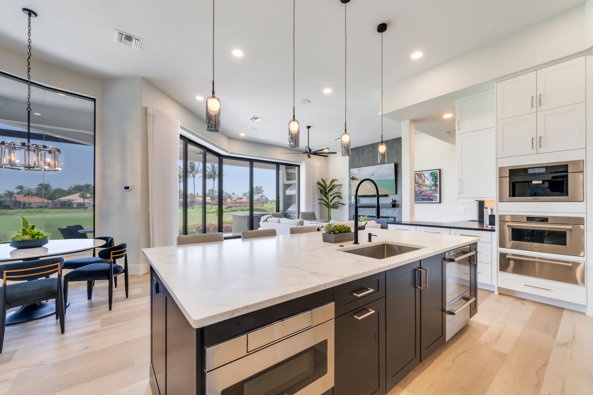 A kitchen with a large island and stainless steel appliances.