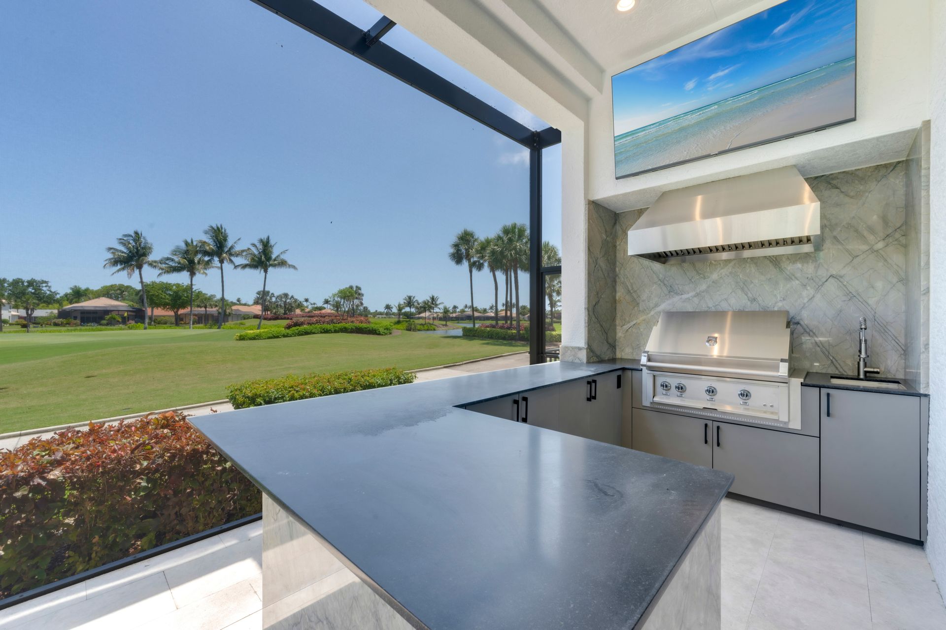 A kitchen with a grill and a view of a golf course