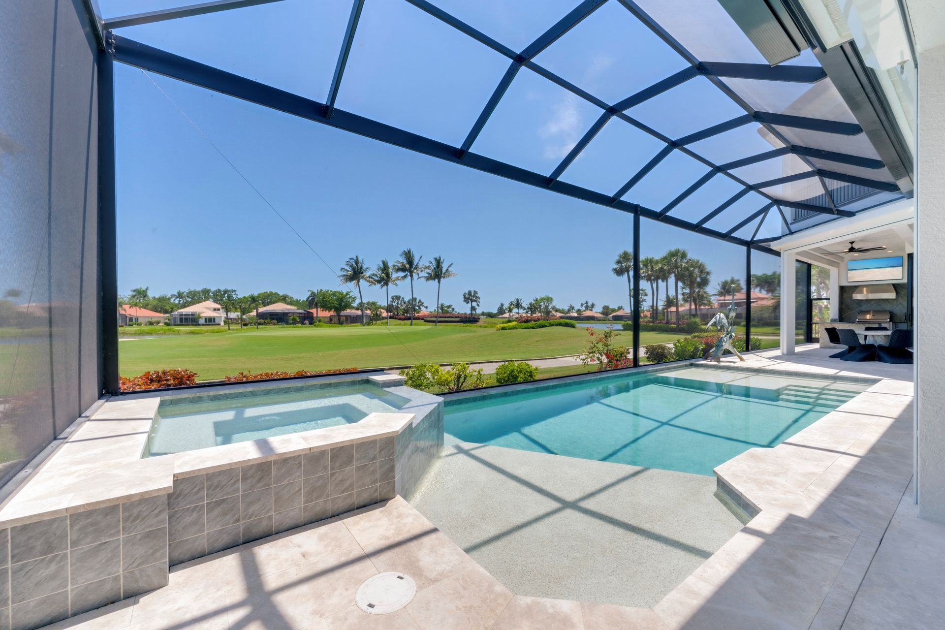 A large swimming pool with a view of a golf course.