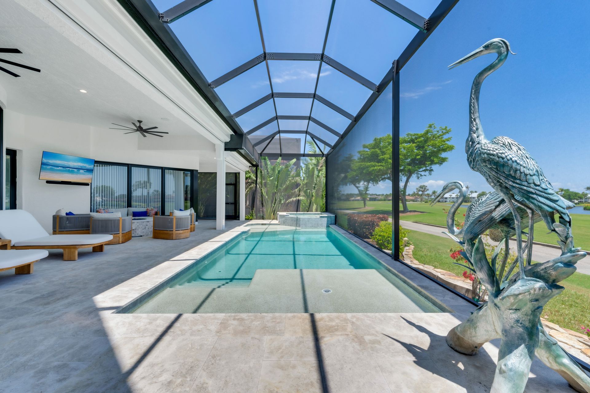 There is a statue of a bird in the middle of a swimming pool.