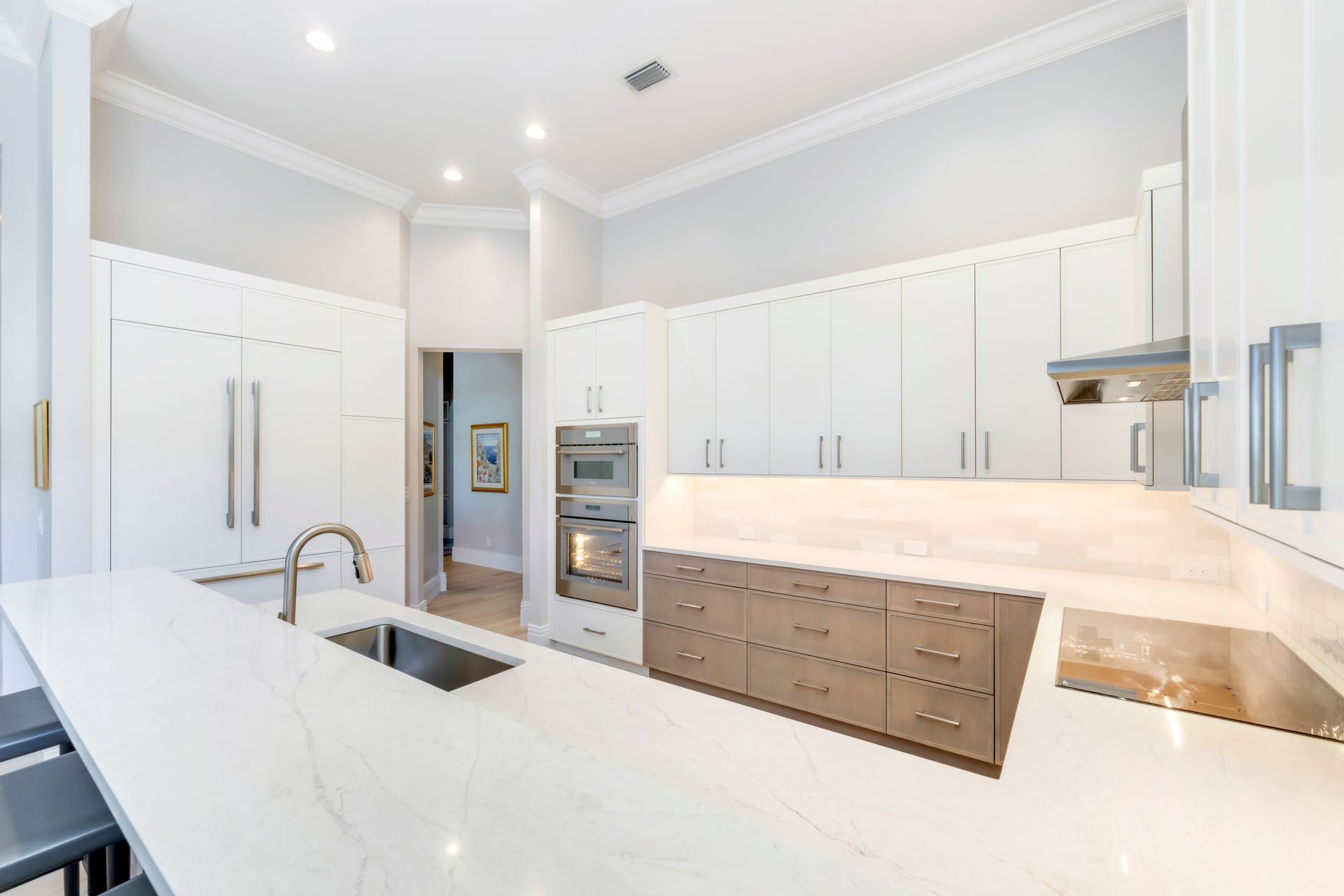 A kitchen with white cabinets and stainless steel appliances.