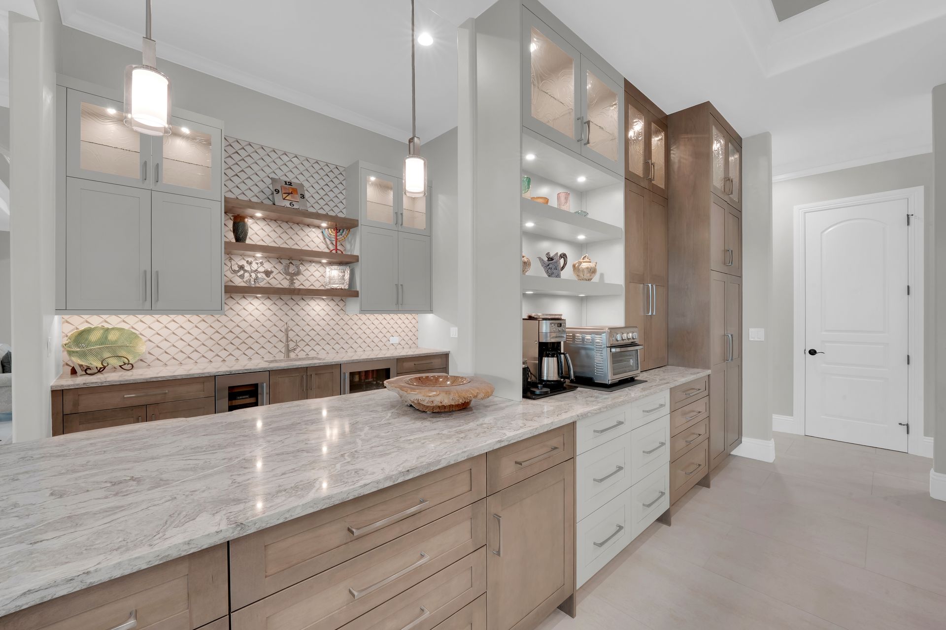 A kitchen with blue cabinets and white counter tops.