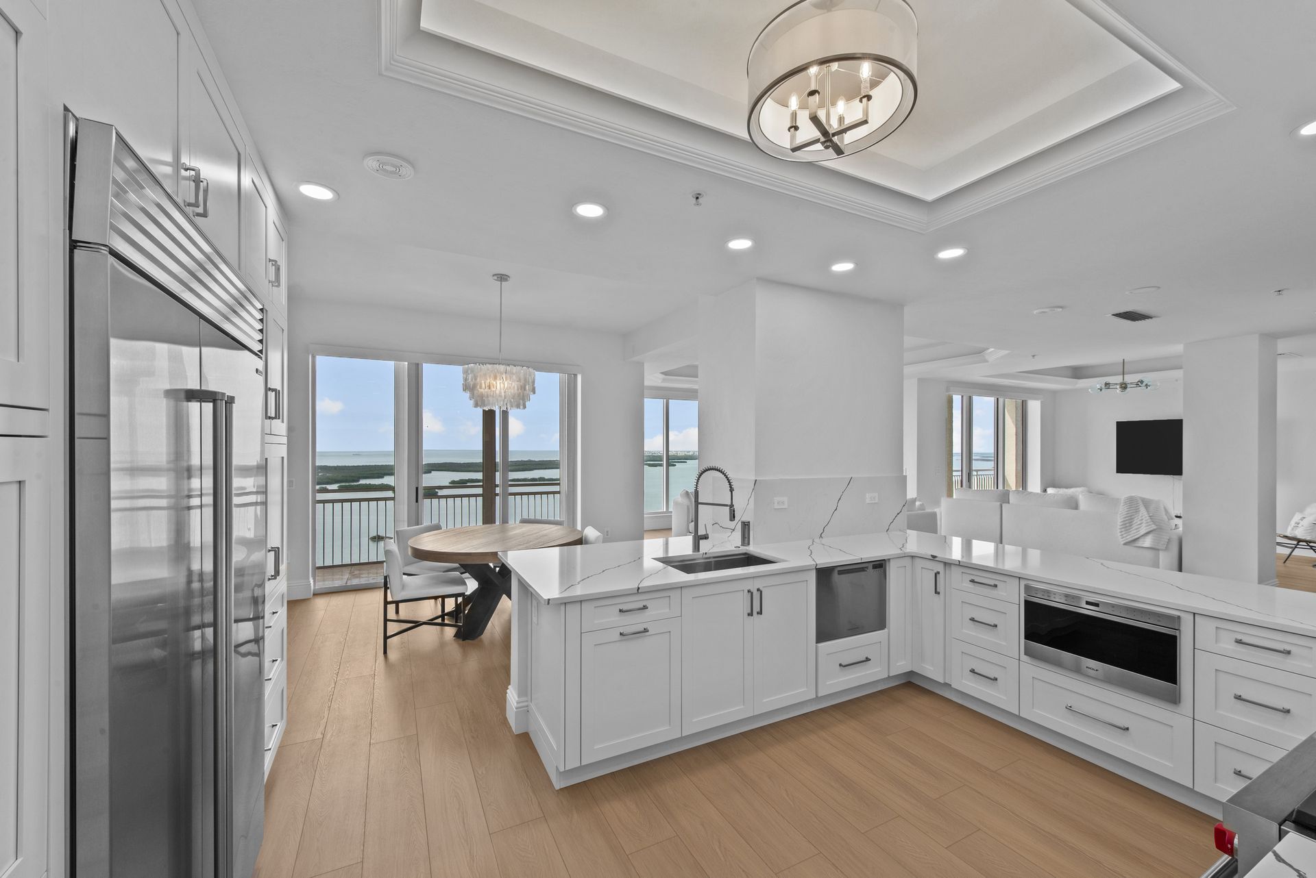 A kitchen with white cabinets and stainless steel appliances