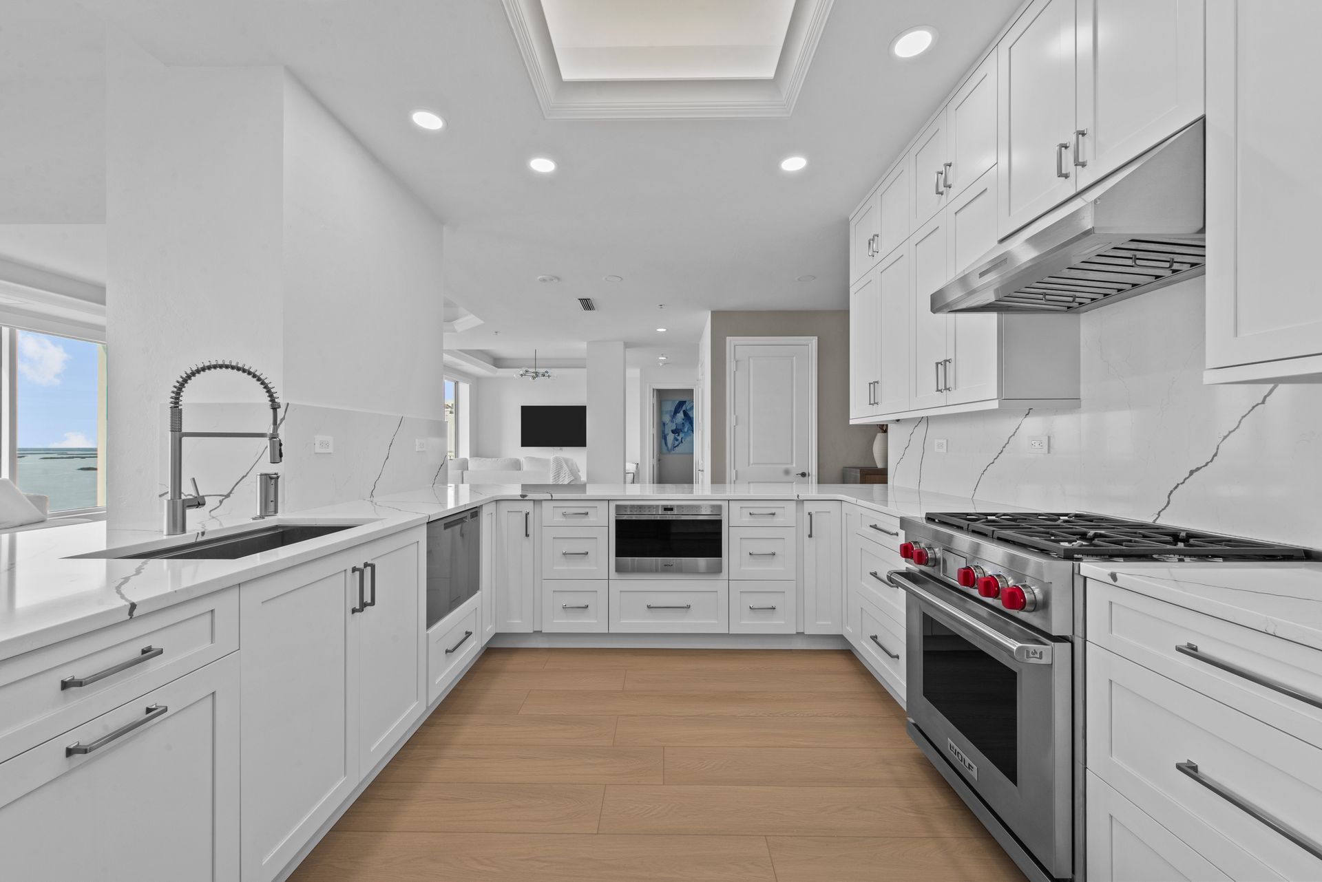 A kitchen with white cabinets and stainless steel appliances.