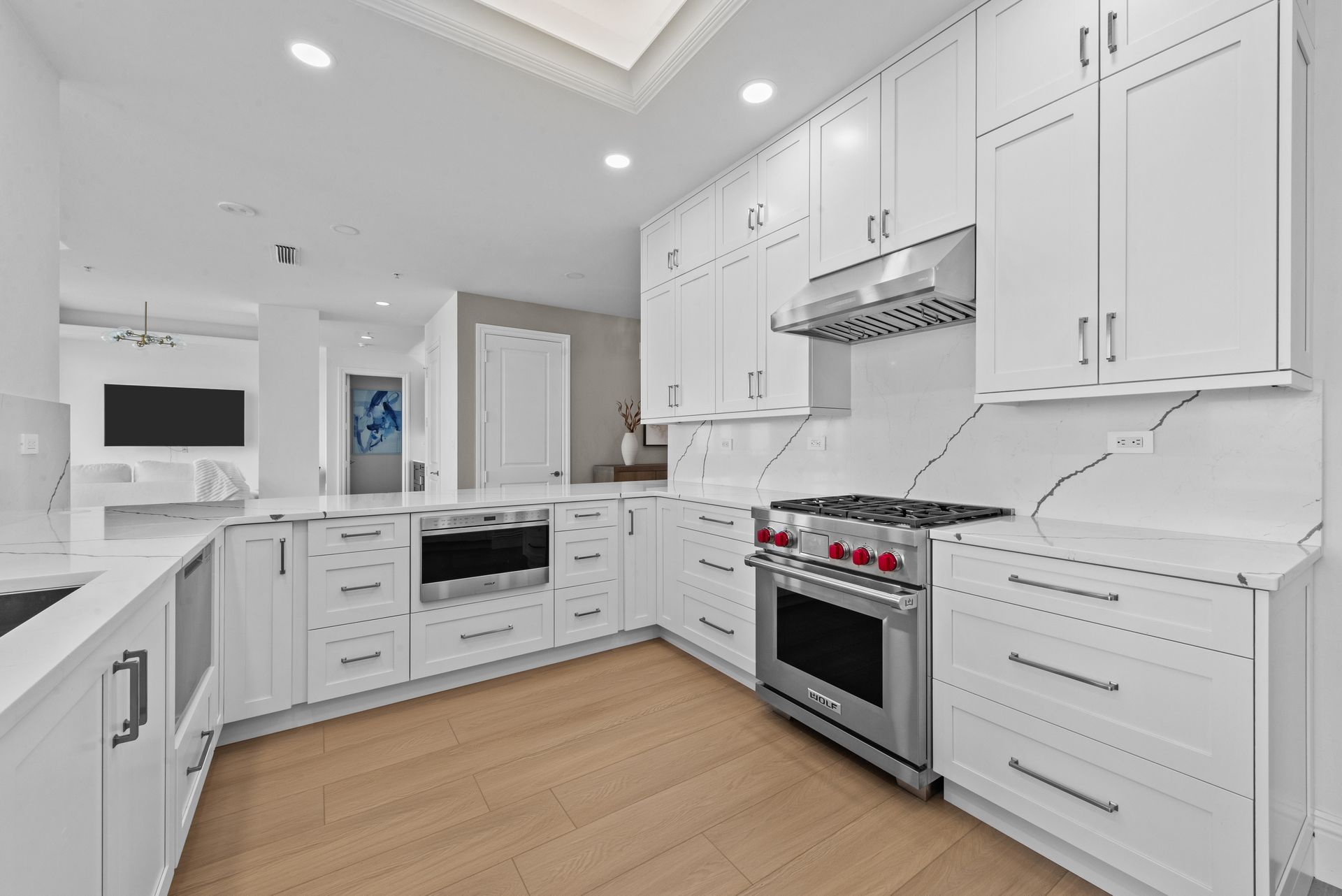 A kitchen with white cabinets and stainless steel appliances