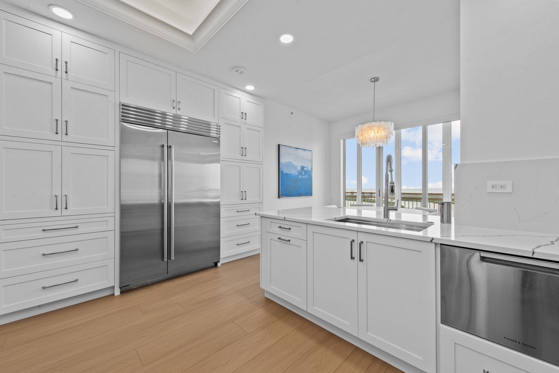 A kitchen with white cabinets and stainless steel appliances