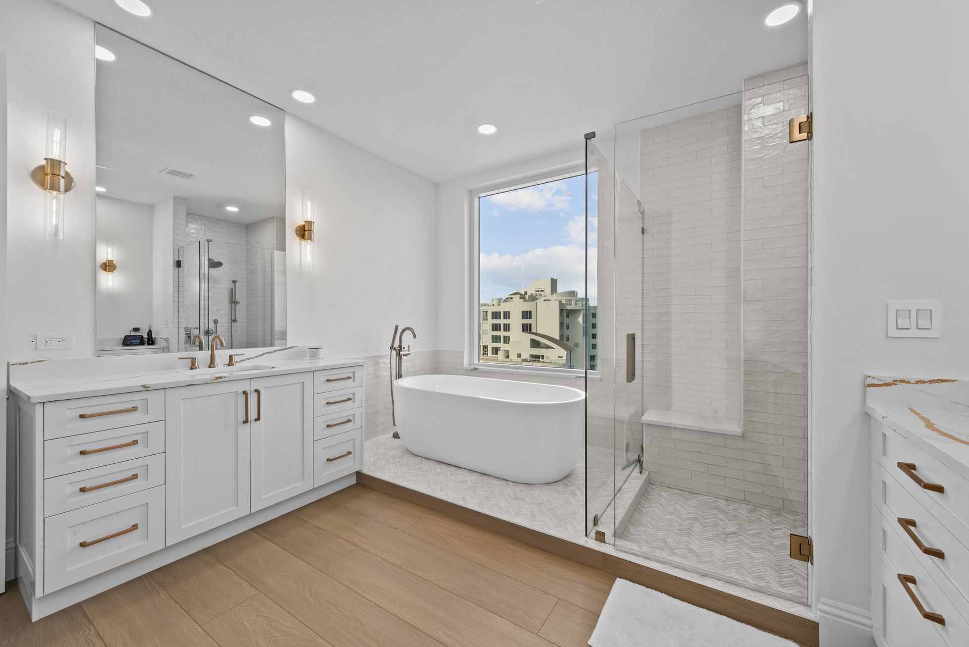 A bathroom with a tub , sink , and shower.