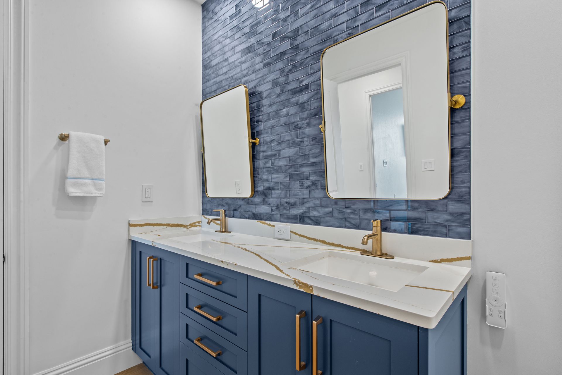 A bathroom with two sinks and two mirrors.
