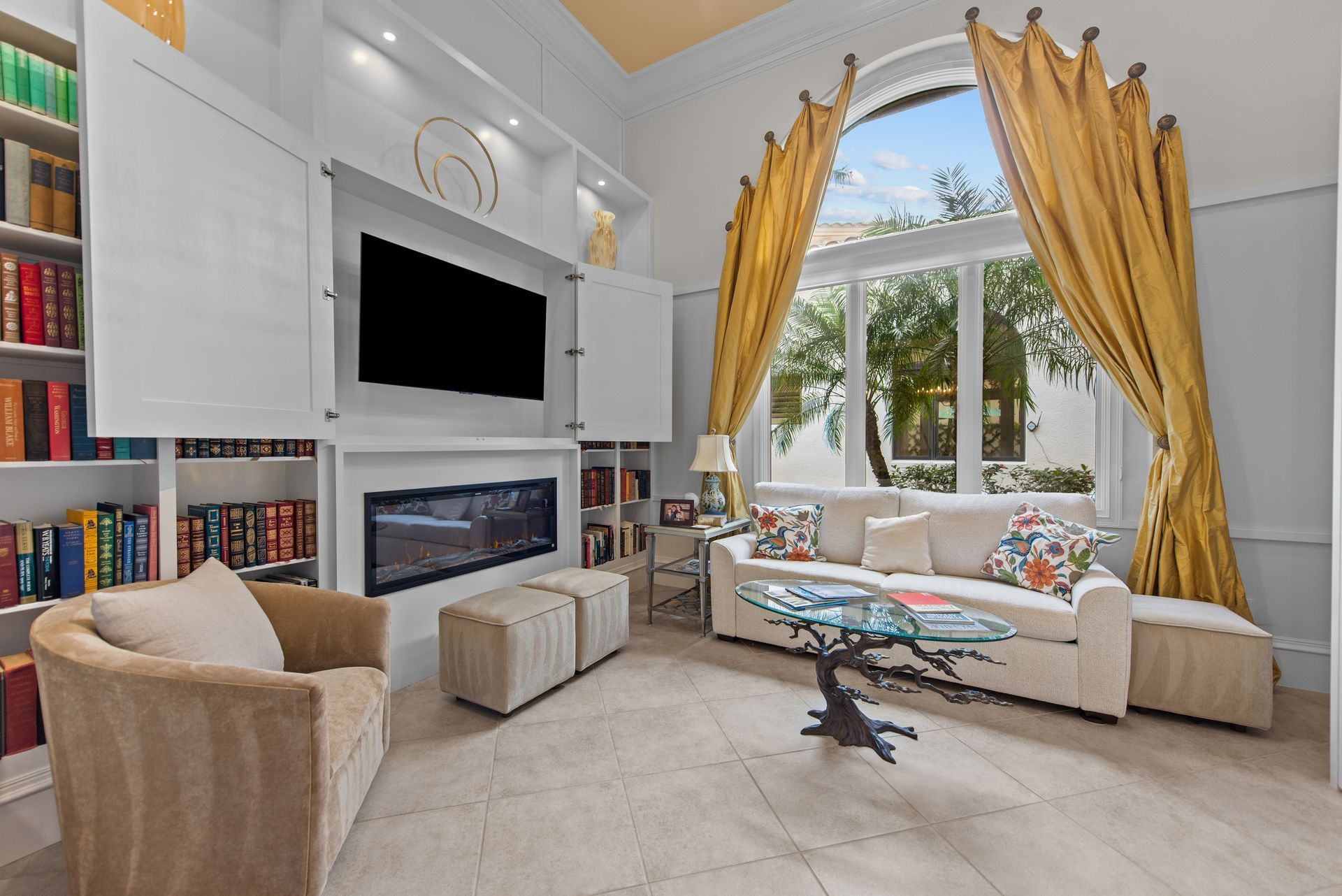 A living room with a couch , chair , table , fireplace and television.