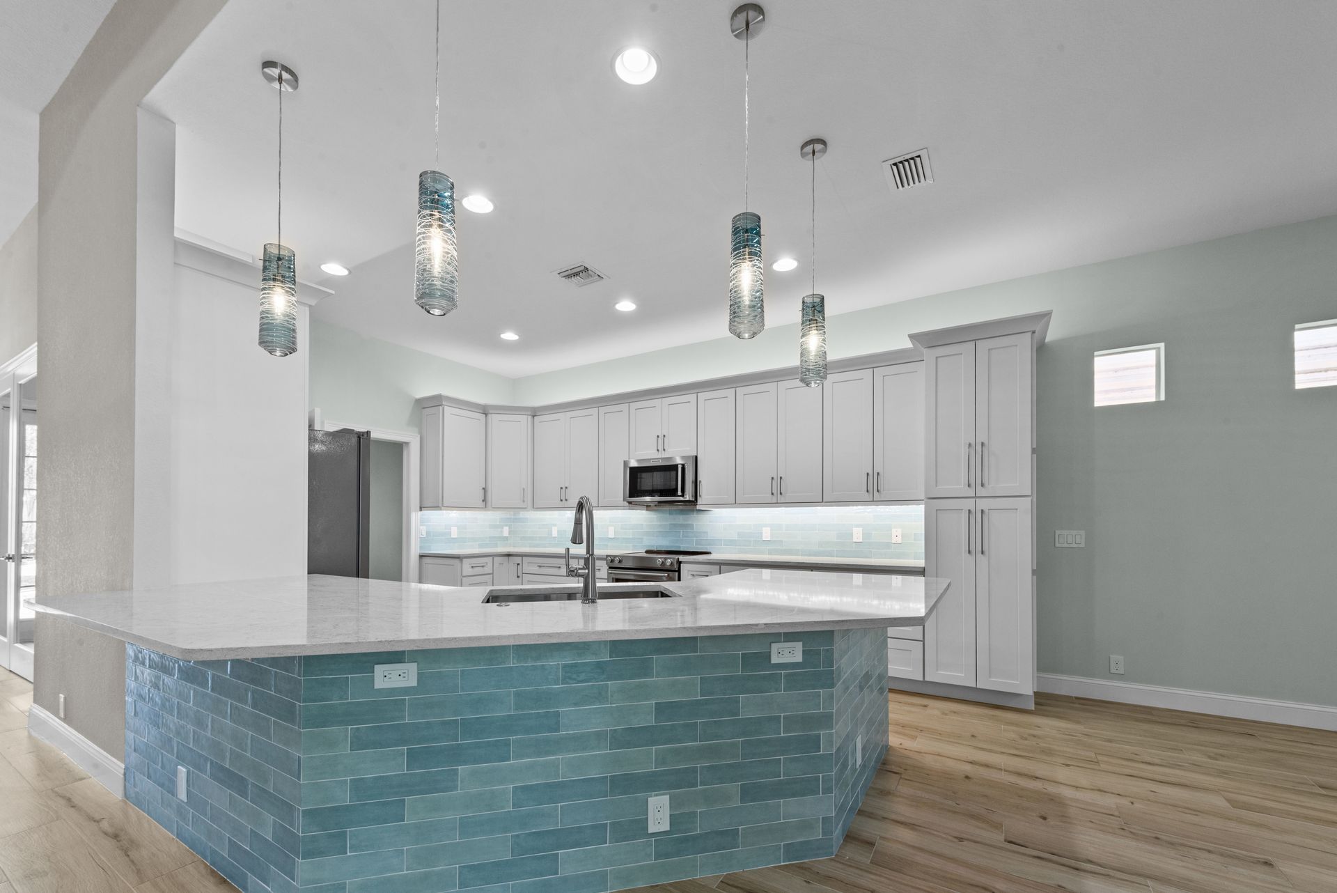There is a large island in the middle of the kitchen.