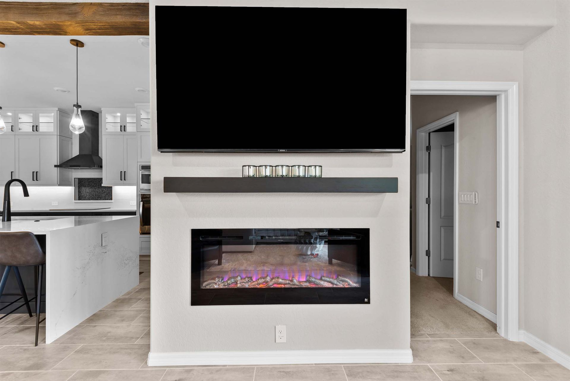 A living room with a fireplace and a flat screen tv above it.
