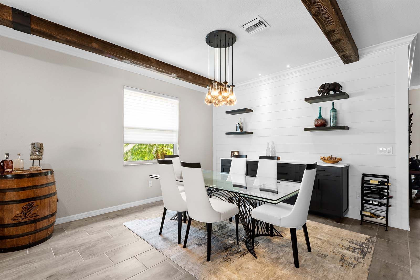 A dining room with a table and chairs and a barrel.