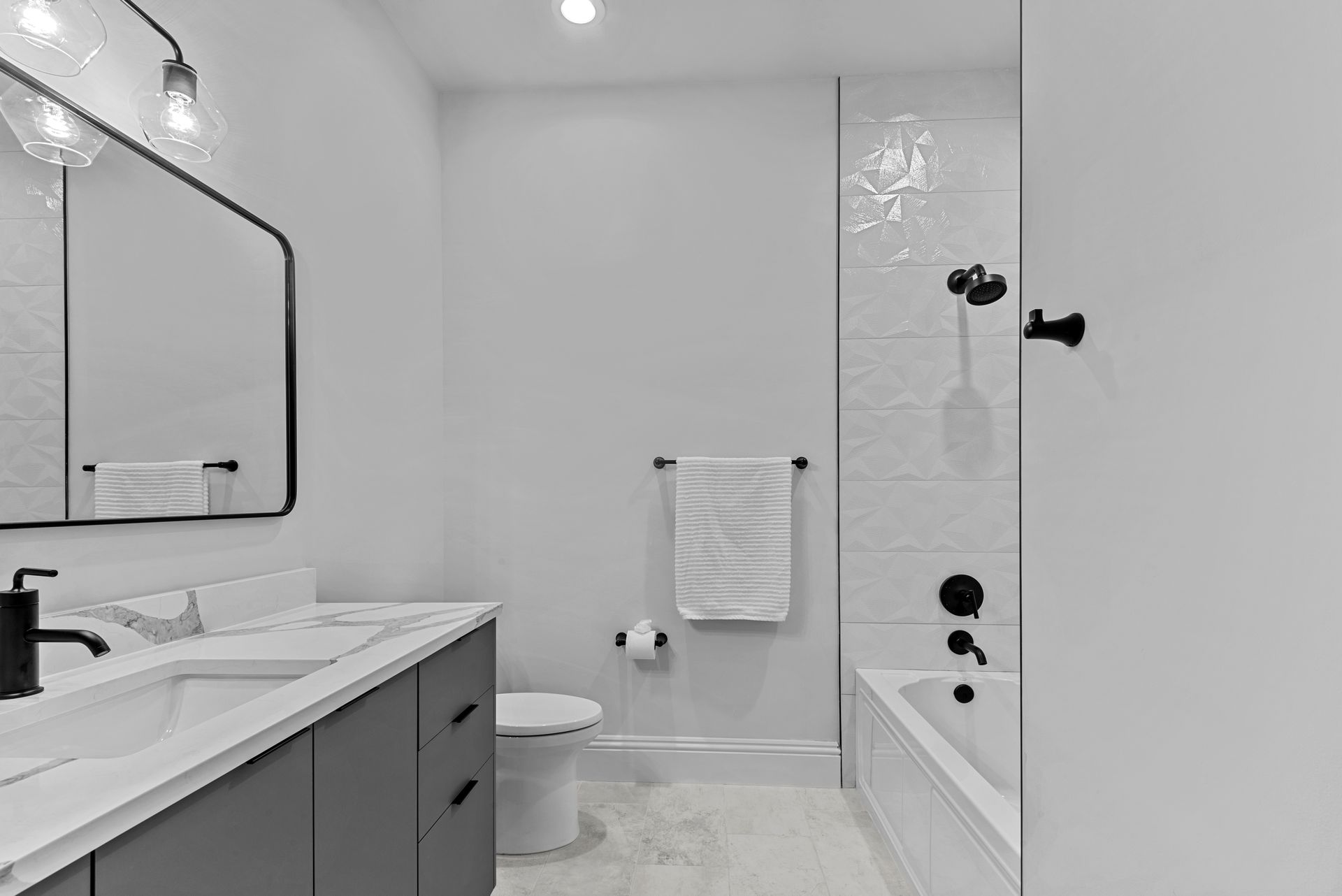 A bathroom with a toilet , sink , mirror and bathtub.