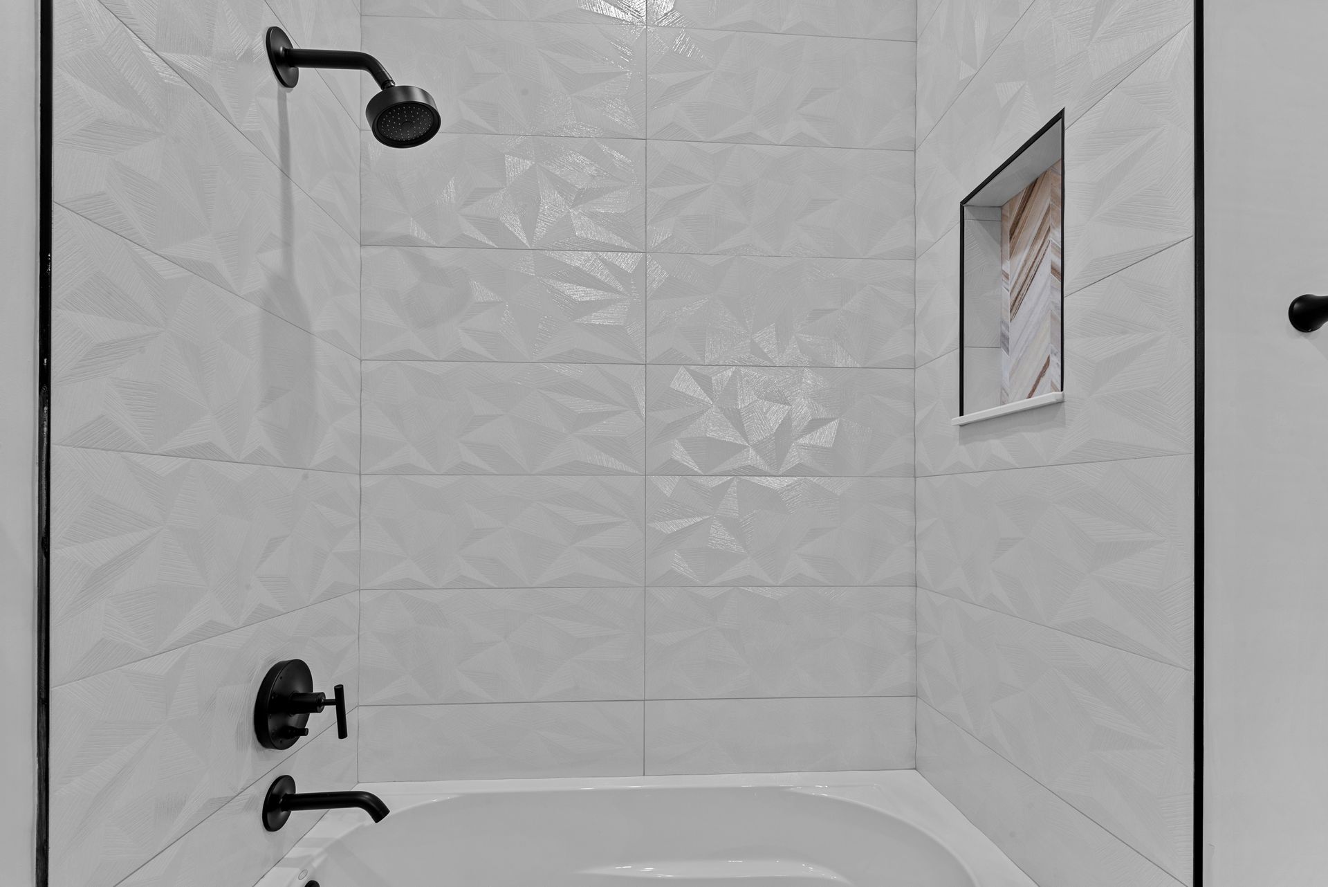 A bathroom with a bathtub and a shower.