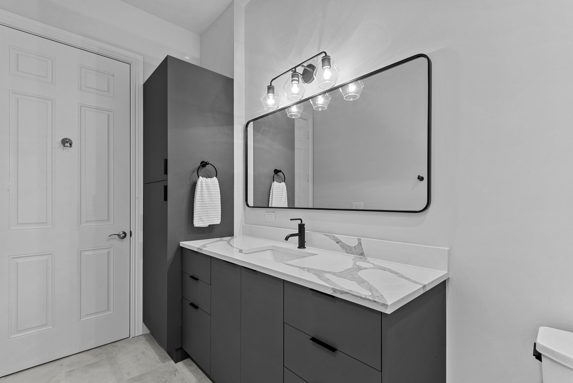 A bathroom with a sink , mirror and toilet.