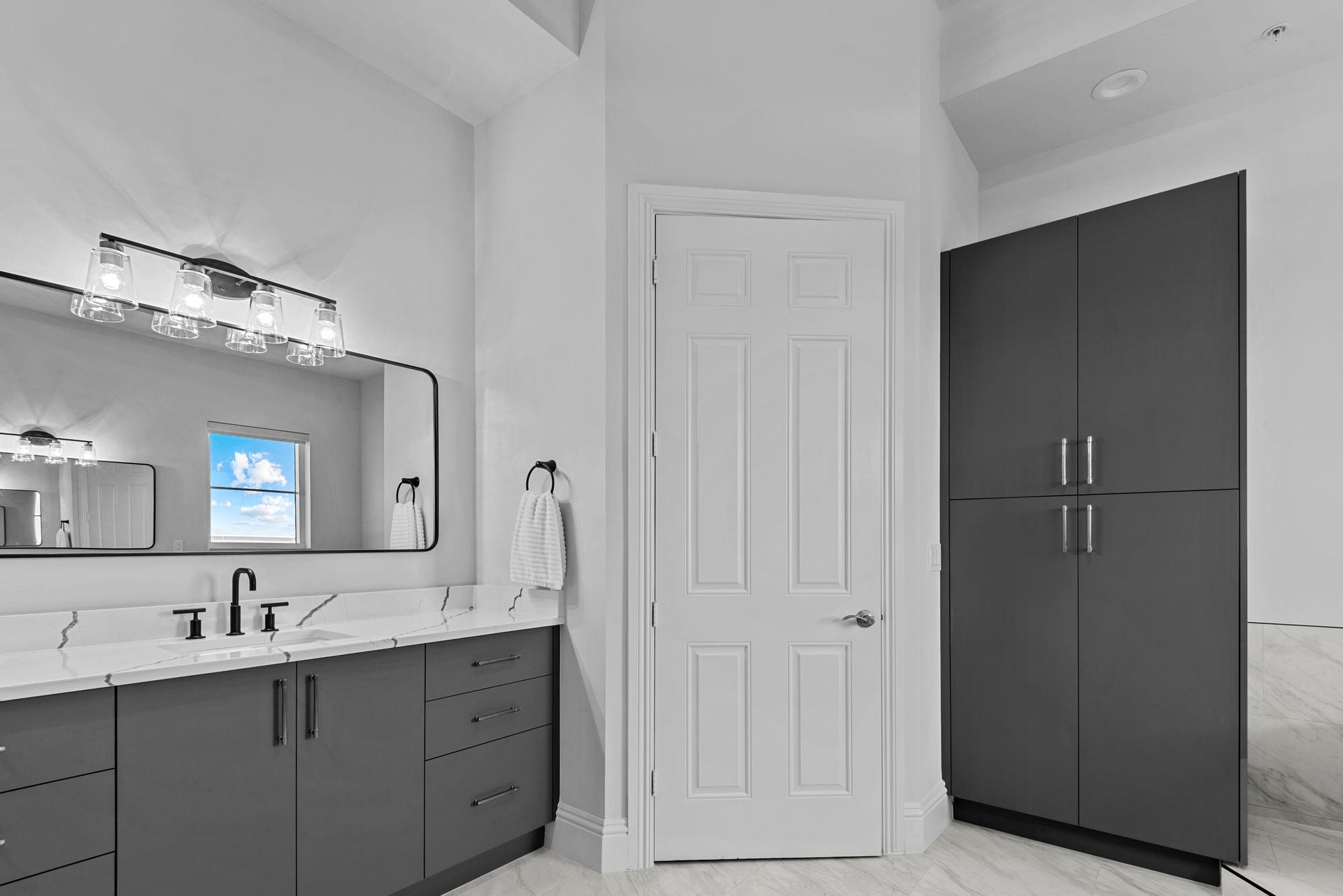 A bathroom with two sinks and a large mirror.
