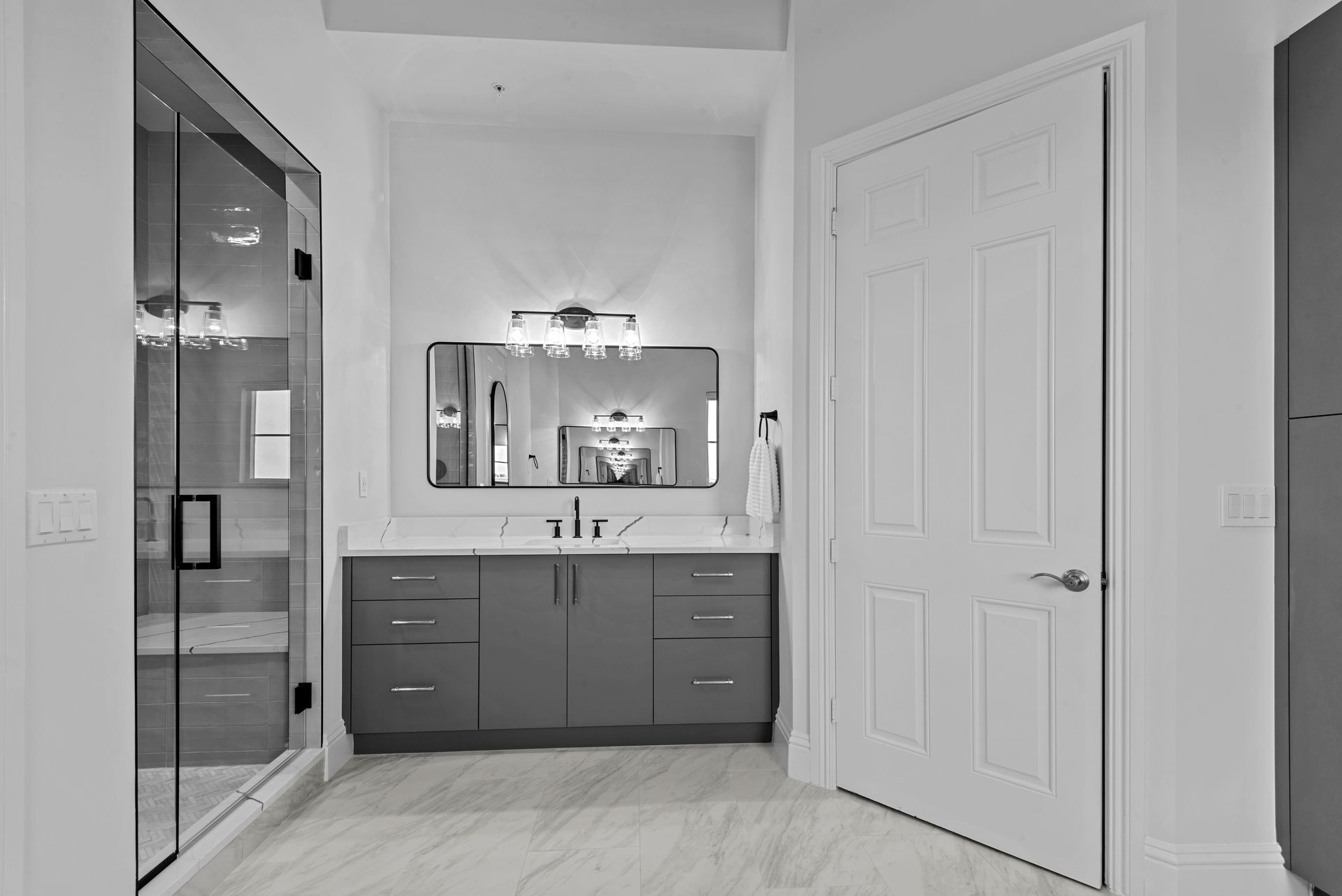 A bathroom with a sink , mirror and walk in shower.
