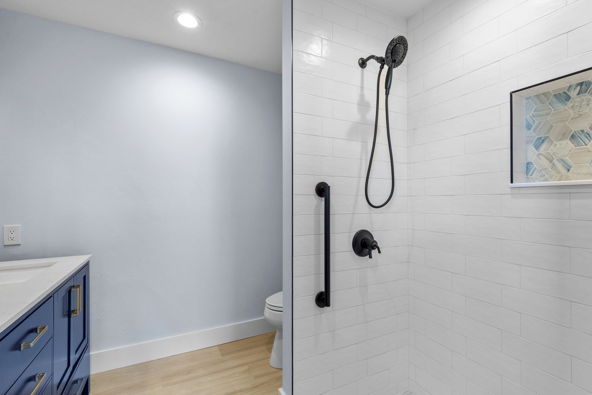 A bathroom with a walk in shower and a toilet.