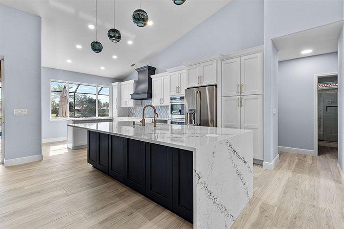 There is a large island in the middle of the kitchen.